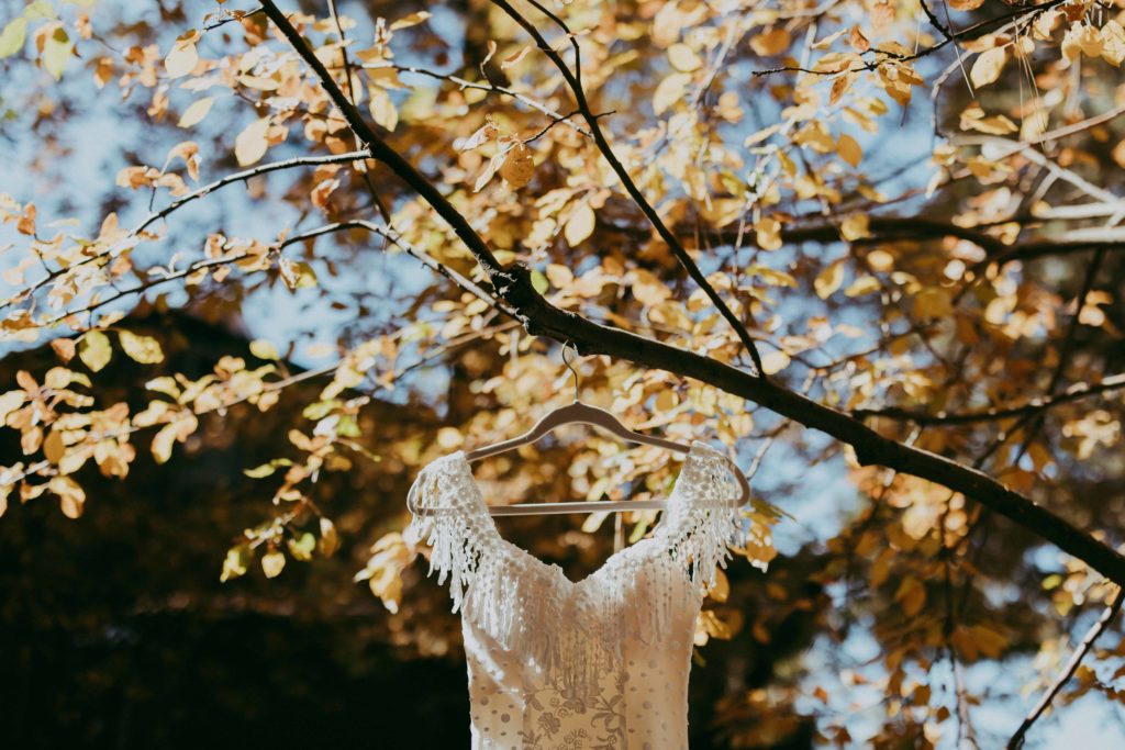 Bohemian wedding dress hanging in a autumn tree